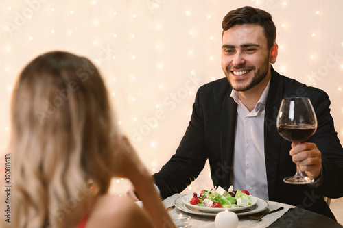 Handsome Man Making Toast On Romantic Dinner With His Girlfriend