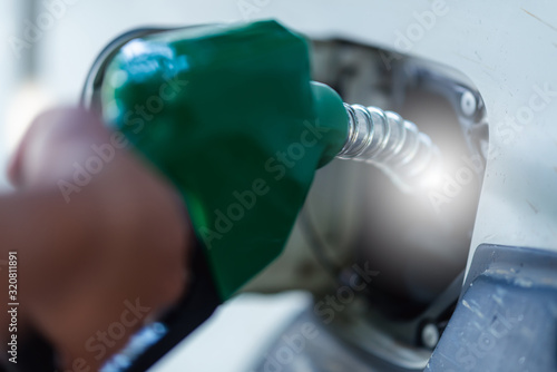 Photos Man Handle pumping gasoline fuel nozzle to refuel