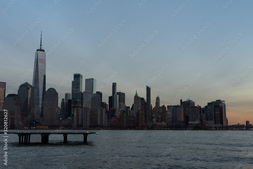 Lower Manhattan New York City Skyline seen from the Jersey City Waterfront with a Helipad during a Sunset