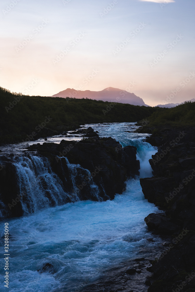 Fototapeta premium Hlauptungufoss waterfall during sunset in Summer