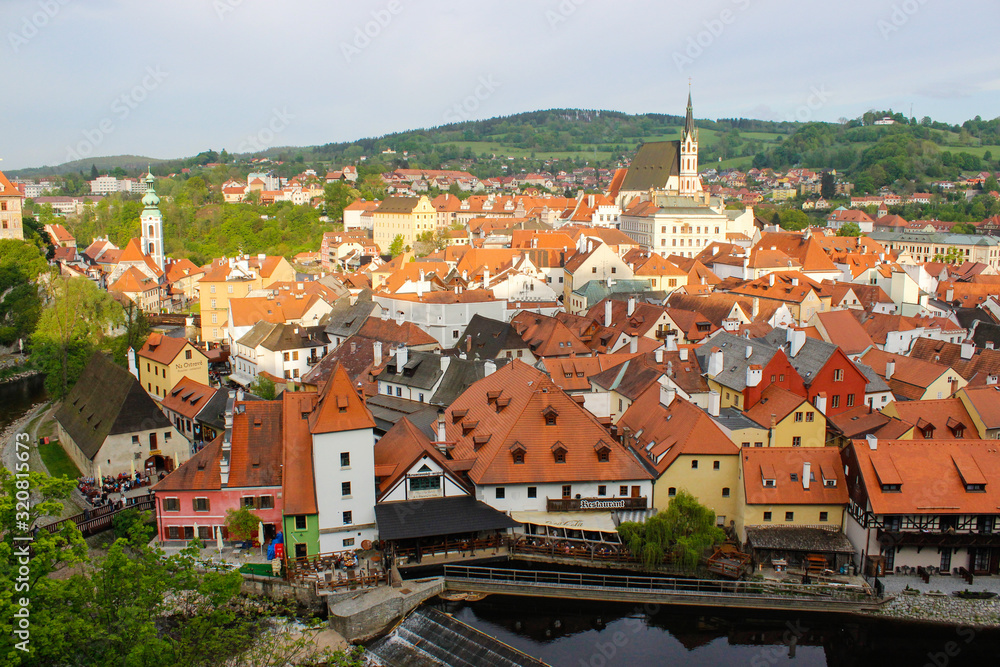 Panoramic view of Cesky Krumlov (Czech Republic) from the Castle, with its typical colorful houses and Vltava river at the foreground