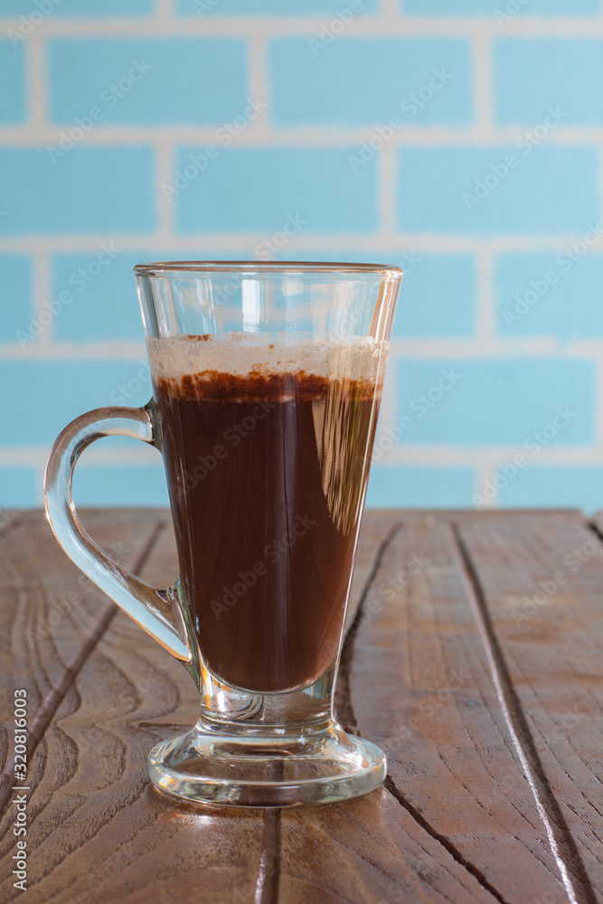 Iced chocolate in tall glass on wooden table served in morning. Iced chocolate in tall glass on wooden table served in morning.