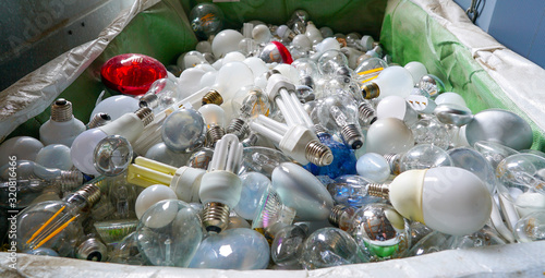 Photography selective focus view of large recycling bin filled with many different size and