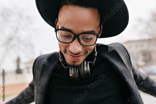 Slika na platnu Close-up portrait of excited guy with dark skin dancing on the street