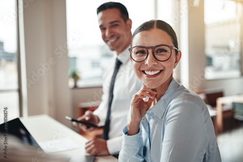 Businesswoman smiling while working with a colleague in an offic