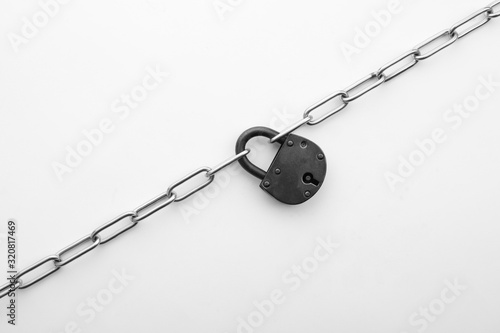 Steel padlock and chain isolated on white, top view. Safety concept © New Africa