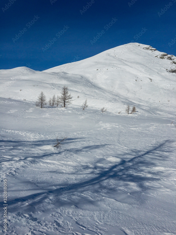 Panoramic view of the snowy Alpe Gattascosa in the high Bognanco valley in winter, Piedmont Italy.