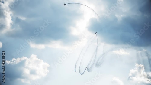 Four fighter jets in the blue sky. A general plan. Aerobatic figures. Airshow. 10 seconds photo