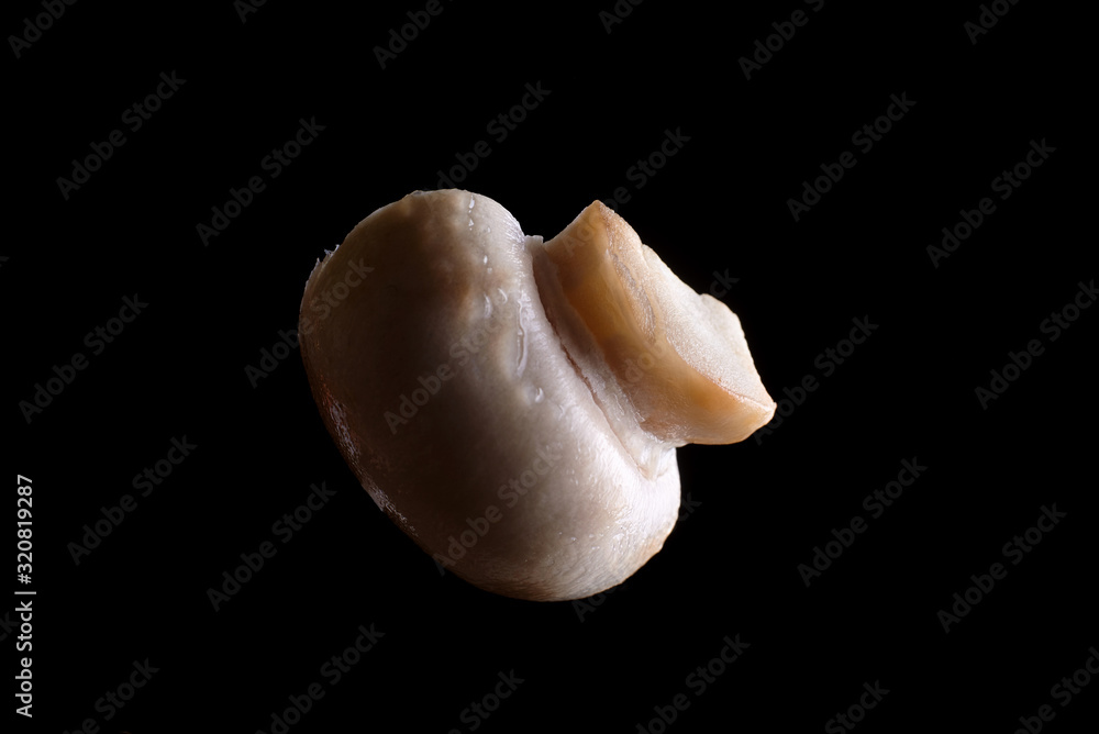 Champignon mushroom close-up on a black background. Champignon mushroom close-up on a black background.