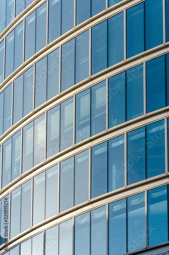 Close up view of detail on a modern glass building with reflective glass and contemporary design.