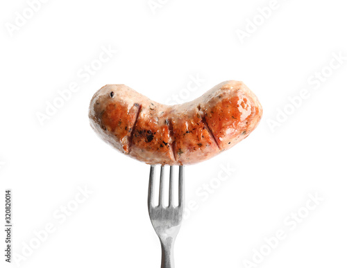 Fork with grilled sausage isolated on white