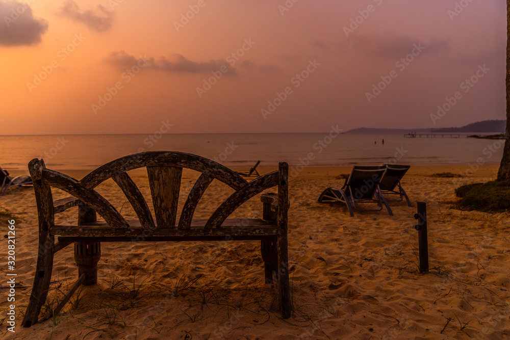 wood bench in sand beach on The beach koh kood a sea thailand in the beautiful sunset time