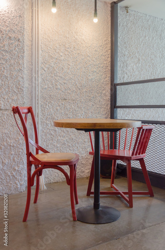 Red chairs and wooden table in coffee shop