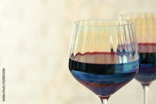 Glasses of red wine on light background, closeup. Space for text