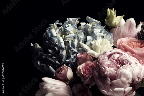 Beautiful bouquet of different flowers on black background. Floral card design with dark vintage effect