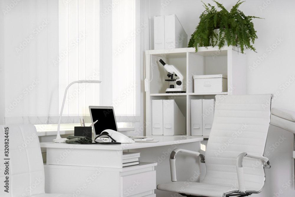 Doctor's workplace near window in medical office Doctor's workplace near window in medical office
