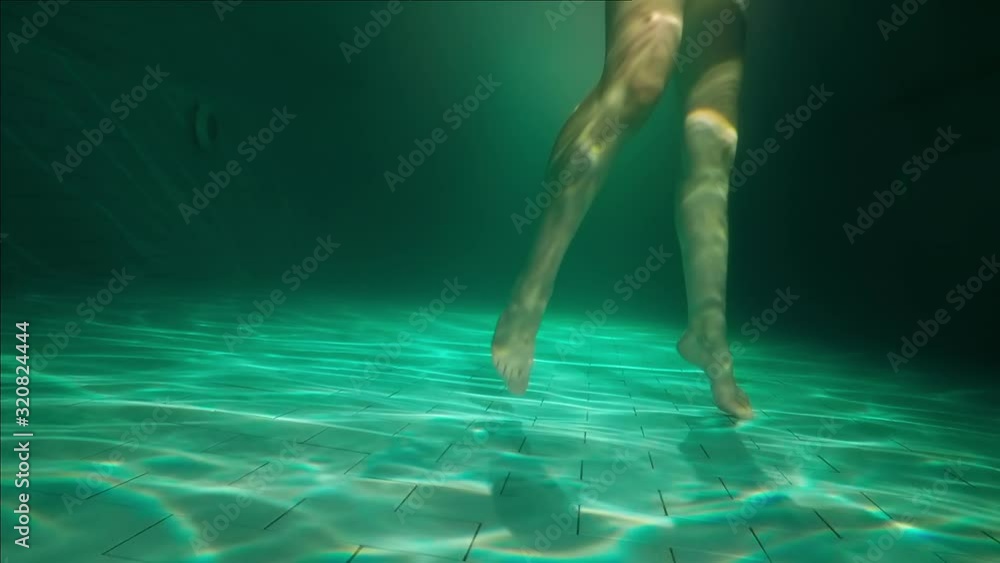 Girl dancing in the pool, underwater view Girl dancing in the pool, underwater view