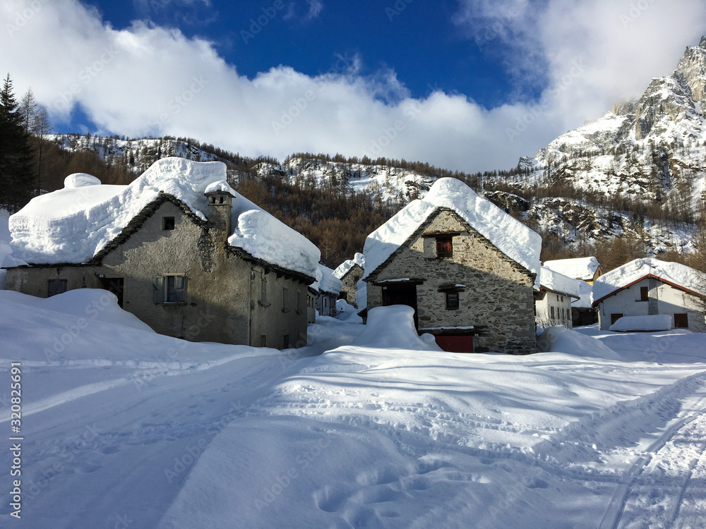 Panoramic view after a heavy snowfall, of the huts of the Alpe Devero village in Piedmont Italy