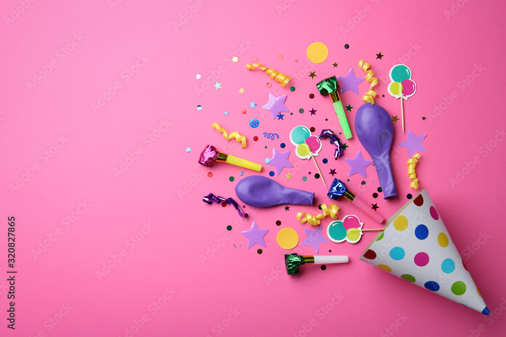 Flat lay composition with party cap on pink background. Space for text Flat lay composition with party cap on pink background. Space for text