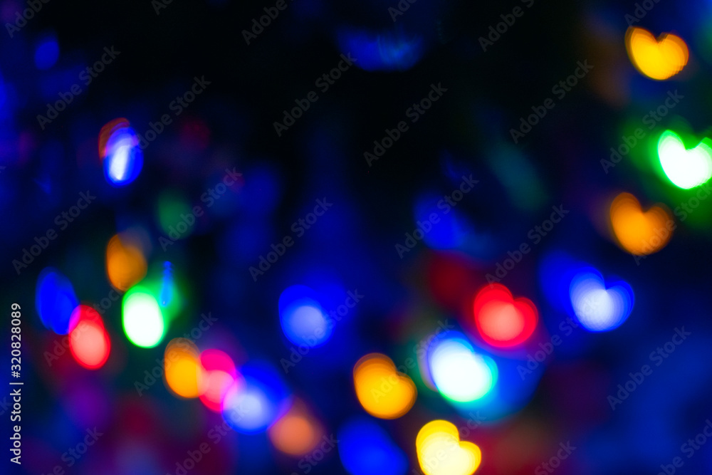 Abstract blur pattern of blue, green, red, yellow lights on isolated black background. Glitter texture of Valentines Day backdrop. New Year light.