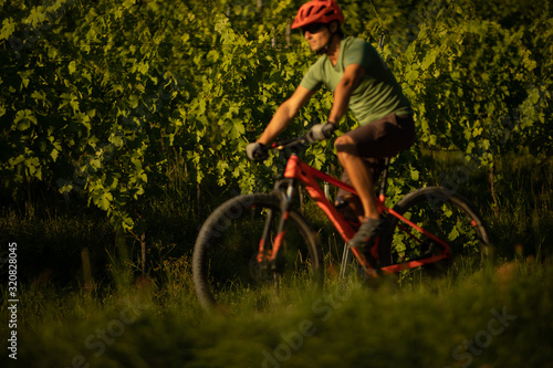 Pretty, young woman biking on a mountain bike enjoying healthy active lifestyle outdoors in summer (shallow DOF) © lightpoet