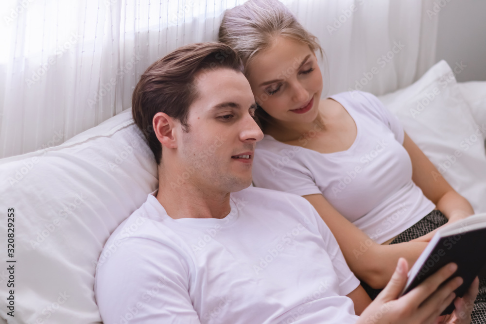 Happy young caucasian couple or lover on bed Happy young caucasian couple or lover on bed