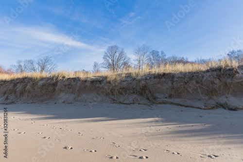 Fototapeta Naklejka Na Ścianę i Meble -  City, Riga, Latvia. Footprints in the sand on Baltic sea. Travel photo.