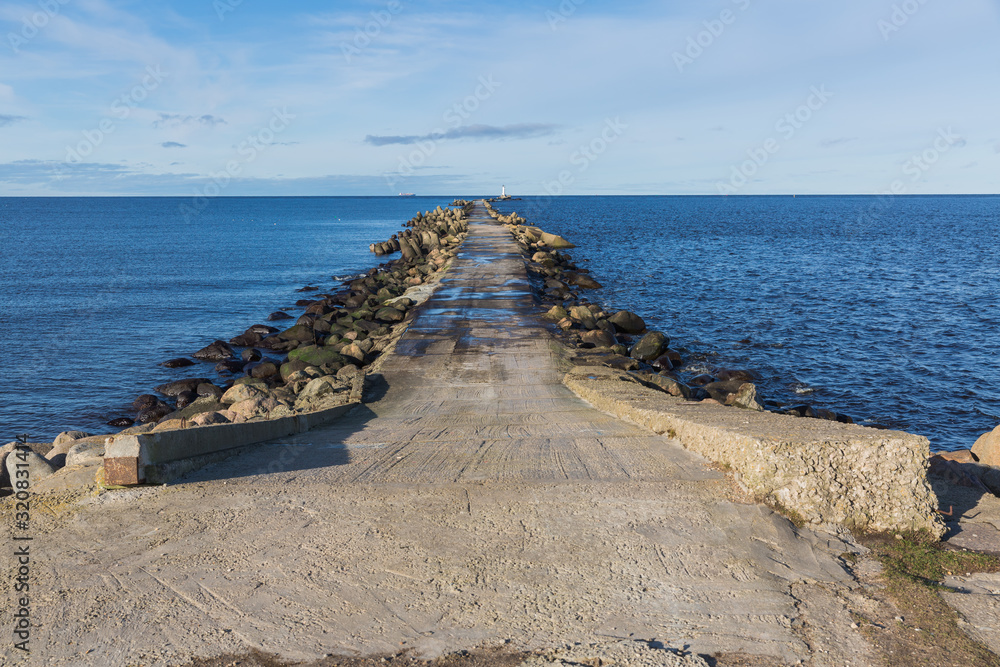 City, Riga, Latvia. Baltic Sea with waves and mole. Travel photo.