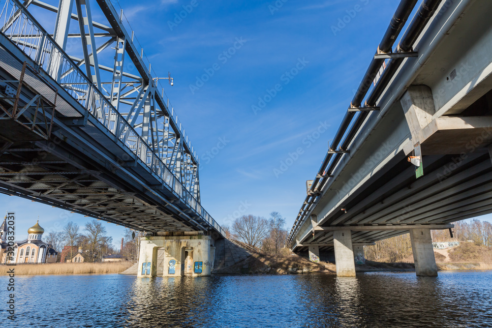 City, Riga, Latvia. River with train bridge with iron construction. Travel photo. 04.02.2020 City, Riga, Latvia. River with train bridge with iron construction. Travel photo. 04.02.2020