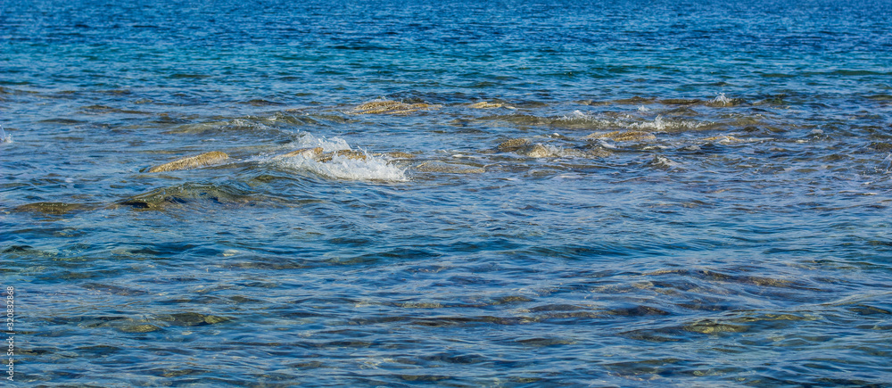 panoramic blue water background surface with stone and splash sea landscape scenic view