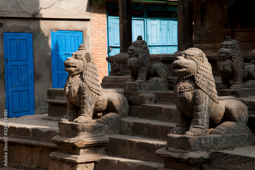 Statue of lions near ancient temple, Nepal