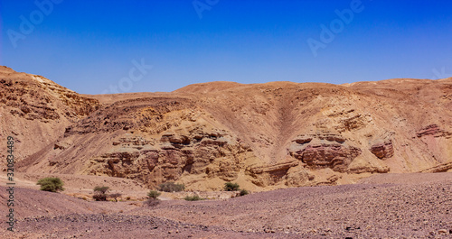 panoramic desert landscape wasteland dry scenic environment sand stone ground and mountain rocks background of Negev Israeli nature site