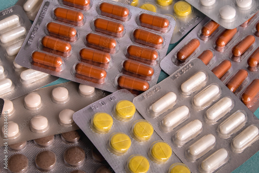 brown yellow pill capsules on a blue background. Disease prevention. Immunity brown yellow pill capsules on a blue background. Disease prevention. Immunity
