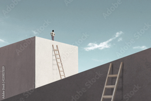 man rising stairs to reach the top of minimalist structure photo