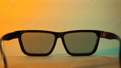 Fototapeta Naklejka Na Ścianę i Meble -  3D cinema glasses close-up on a colored background