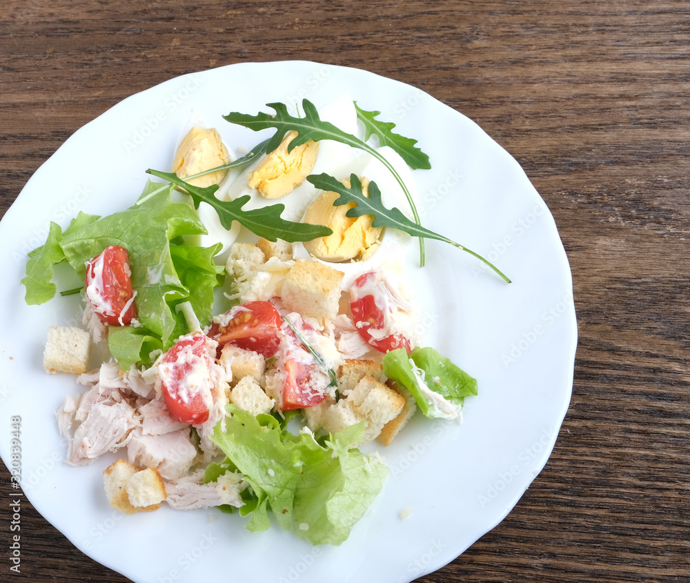 caesar salad in oak plate