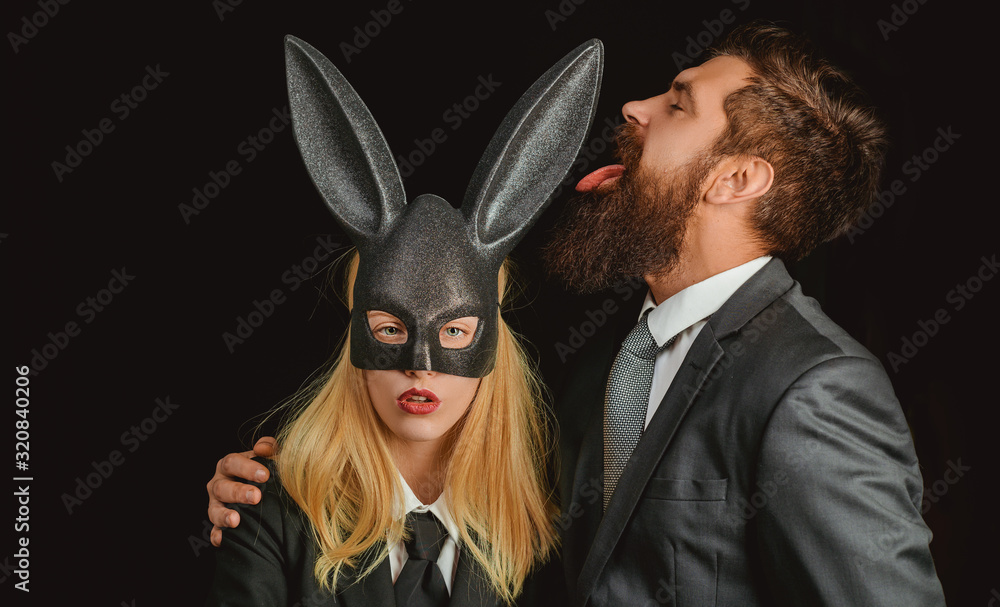 Bunny mask woman. Serious man with beard. Rabbit and girl. Lovely woman in  rabbit costume. Stylish man. Young girl easter woman in bunny ears. foto de  Stock | Adobe Stock