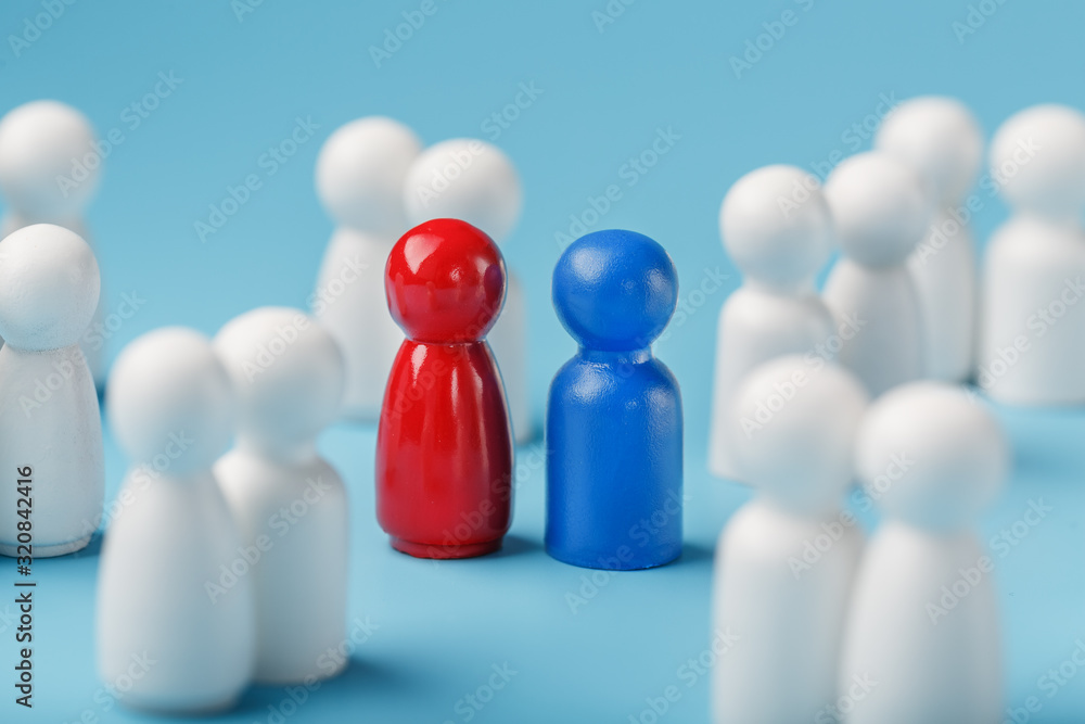 Choosing a sexual partner for love, relationships from such a crowd of monotonous people. A red woman and a blue man in a crowd of white people. Choosing a sexual partner for love, relationships from such a crowd of monotonous people. A red woman and a blue man in a crowd of white people.