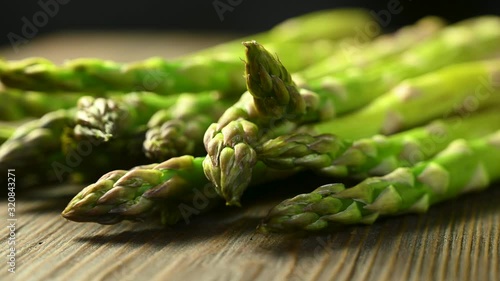 green asparagus lies on a wooden table