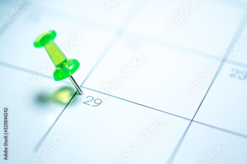 Photography Green push pin on calendar 29th leap year day of the month