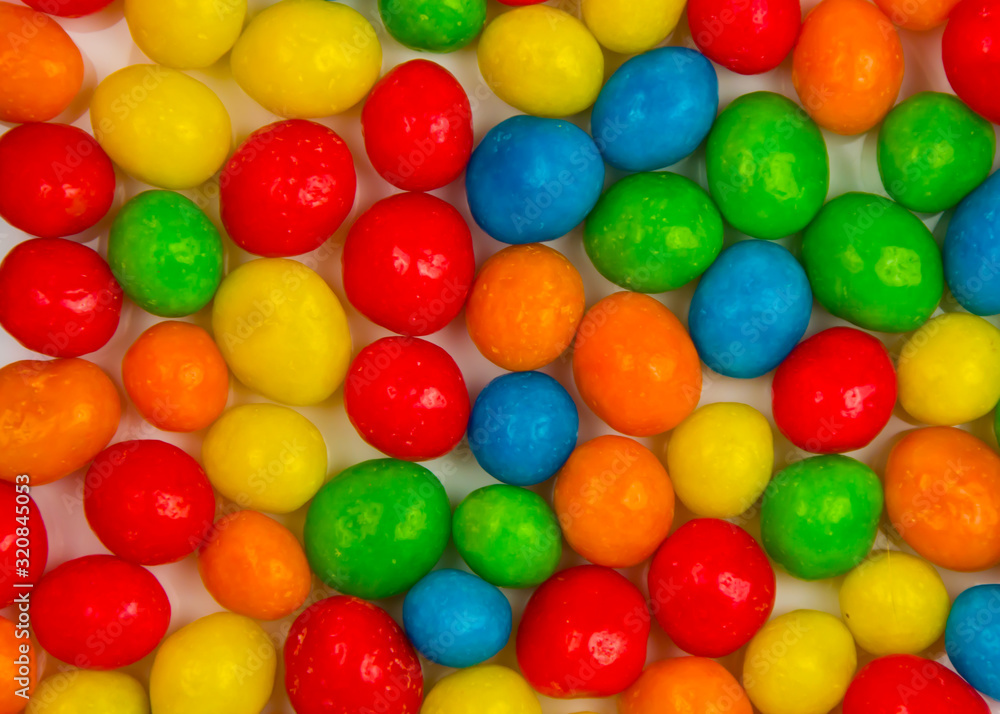 background from multi-colored chocolate candy dragees close up background from multi-colored chocolate candy dragees close up
