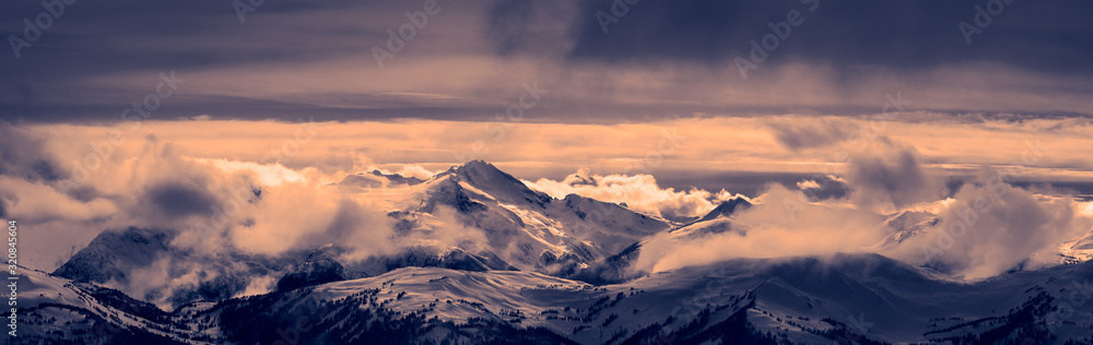 Whistler, British Columbia, Canada. Beautiful Panoramic View of the Canadian Snow Covered Mountain Landscape during a cloudy and vibrant winter sunset. Black and White Art Tint