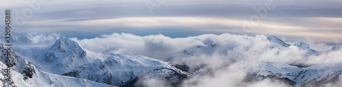 Whistler, British Columbia, Canada. Beautiful Panoramic View of the Canadian Snow Covered Mountain Landscape during a cloudy and vibrant winter sunset. © edb3_16