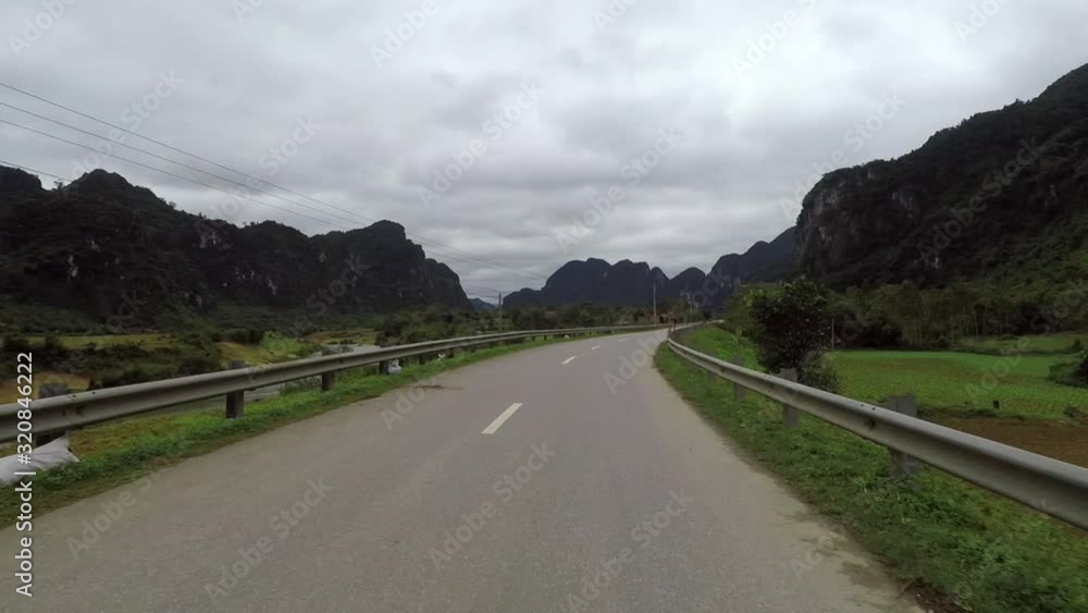 Driving on a Road Through Huge Luscious Mountains in Vietnam. Driving on a Road Through Huge Luscious Mountains in Vietnam.