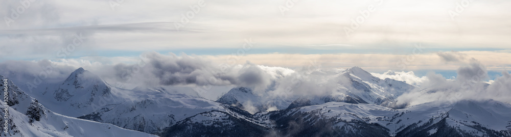 Whistler, British Columbia, Canada. Beautiful Panoramic View of the Canadian Snow Covered Mountain Landscape during a cloudy and vibrant winter day.