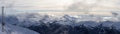 Whistler, British Columbia, Canada. Beautiful Panoramic View of the Canadian Snow Covered Mountain Landscape during a cloudy and vibrant winter day. © edb3_16