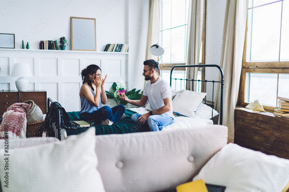Boyfriend congratulating girlfriend with gift at home Boyfriend congratulating girlfriend with gift at home