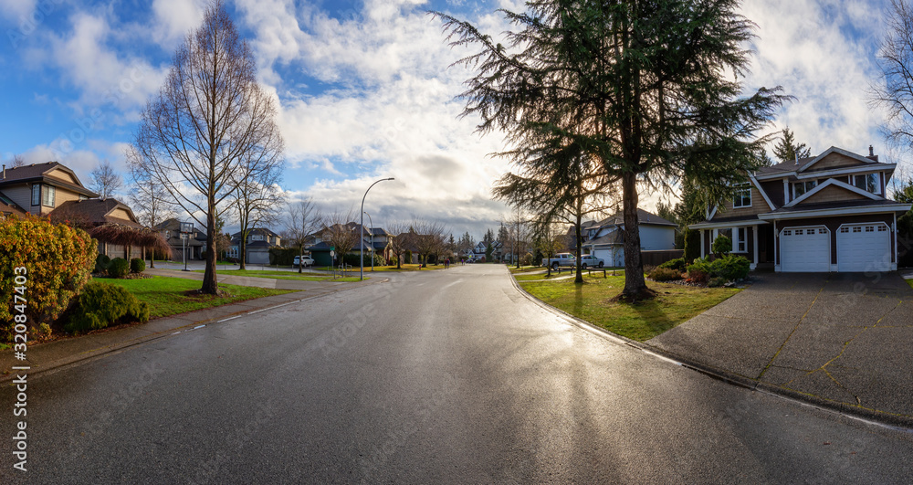 Residential Suburban Neighborhood in the City during a vibrant winter sunrise. Taken in Fraser Heights, Surrey, Vancouver, BC, Canada. Panorama, Wide Angle