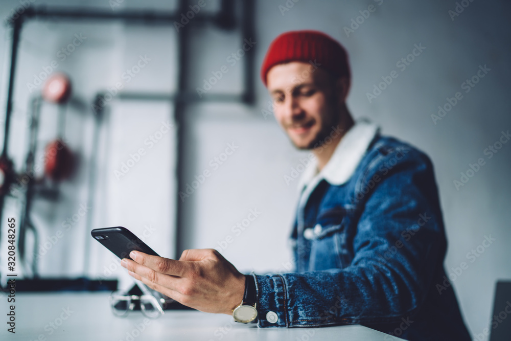 Soft focus freelancer using phone at workplace Soft focus freelancer using phone at workplace