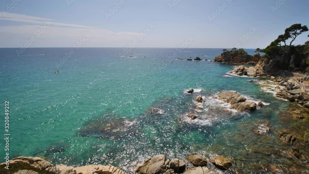 Beautiful Mediterranean beach of the Costa Brava Girona leafy green vegetation and turquoise blue sea
